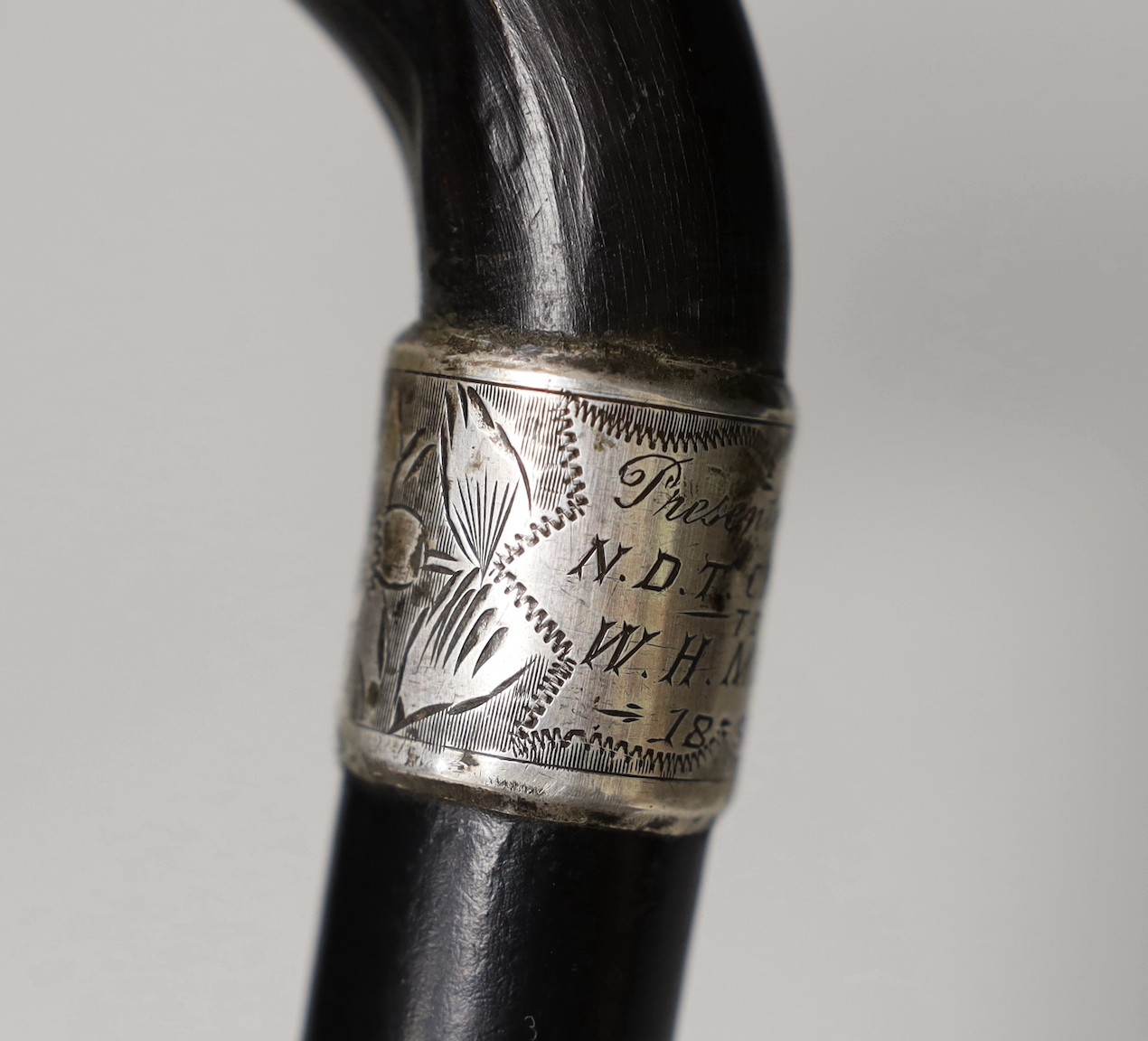 A silver mounted ebony cane with a phallic shaped handle, presented by N.D.T. Chapel to W.H. Miles, 1899. 82cm high